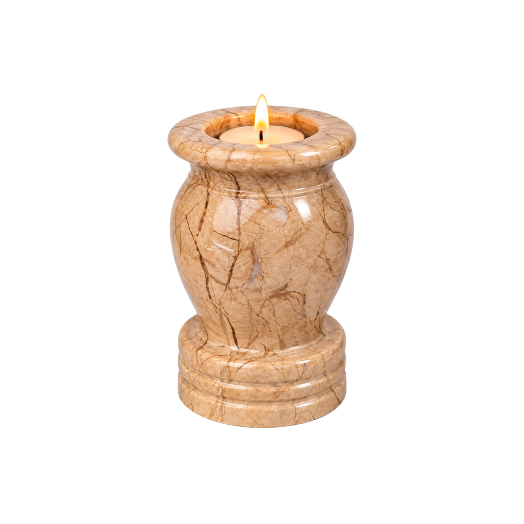 A lit tea light candle holder urn in a round, flared stone holder with a bulbous center and tiered base, finished in a warm beige marble pattern with brown veining, isolated on a white background.